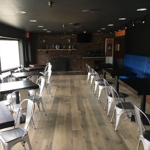 The interior of J&R's Steakhouse with Longhorn hardwood floors.